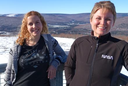 Astrophysicists Lindsay Glesener, left, and Sabrina Savage enjoy the sunshine on an observation deck at the Neil Davis Science Center on a hilltop at Poker Flat Research Range north of Fairbanks. Photo by Ned Rozell.